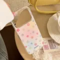 Macro detail view of an iPhone case featuring colorful flowers and subtle glitter texture - White Quicksand Childlike Flower (Non-Magnetic) / 17promax
