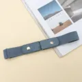 Detail close-up view of a stylish blue lazy invisible elastic waist belt with metal snap buttons. - Light Blue