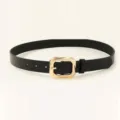 Detailed view of a minimalist black leather belt featuring a sleek gold geometric buckle - 102cm / Black
