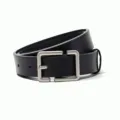 Detail shot of a minimalist black leather belt featuring a sleek silver square pin buckle. - Black