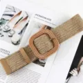 Close-up of the stylish woven straw wide belt featuring a unique square rattan buckle design. - Khaki