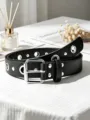 Detail view of the black punk style leather belt featuring metal eyelets and silver buckle. - Black