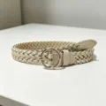 Detailed view of women's braided belt in beige with round gold buckle casual accessory - Khaki