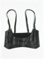 Detailed macro view of black punk style suspender corset with silver metal buckles - Black