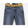 Close-up detail of a vibrant yellow canvas belt featuring double metal grommets on blue denim - One Size 100cm / Yellow