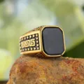 Macro detail of men's gold signet ring with black stone and Greek key pattern - Size 7 / Gold