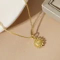 Macro view of a delicate gold-plated sunflower pendant necklace on a box chain - Sunflower