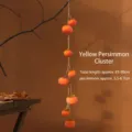 Rustic hanging artificial persimmon string wall decor with realistic frost finish. - Yellow