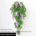 Vibrant purple artificial hanging lantern flower plant with lush green leaves and vines - Purple