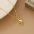 Detail view showing a gold-plated star pendant necklace with a sparkling inset zircon stone - Pointed Four-Pointed Star