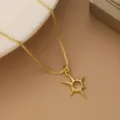 Close-up of a gold-plated star pendant necklace on a tan leather background - Hollow Star Sun