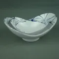 Detailed side view of two nested irregular white melamine bowls with elegant blue branch patterns - Ingot Bowl / White Patterned