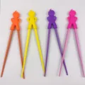 Colorful kids training chopsticks set with cute silicone cartoon figure heads for baby learning 18cm - Random Akimbo Boy