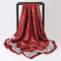 Detail showing the red polka dot satin square scarf with elegant paisley border - 90x90cm / K136-Wine Red