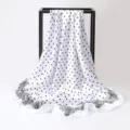 Detailed view of a white satin square scarf with black polka dots and paisley border. - 90x90cm / K136-White
