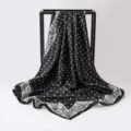Close-up of 90cm black and white polka dot satin scarf with paisley pattern border - 90x90cm / K136-Black
