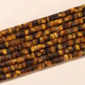 Macro detail view of 4x2mm natural yellow tiger eye disk spacer beads for DIY jewelry. - Flat Disc Style / 155 Pieces/Strand / Tan