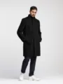 Men's solid black trench coat detail view showcasing lapel collar and side pockets design. - S / Tops / Black