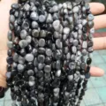 Macro detail view of natural grey eagle eye stone tumbled beads for jewelry making - Natural Eagle Eye Stone Irregular / 8-10mm (Approx 35-45 Pieces/Strand)