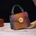 Elegant vintage handbag featuring colorful crocodile embossed leather and a gold clasp detail. - Teal