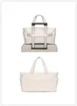 Cream quilted travel tote bag featuring a practical trolley sleeve on a suitcase - Puffer White