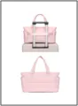 Pink quilted travel bag showing the luggage strap fixed on a suitcase handle - Puffer Pink