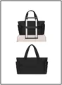 Detail view of black quilted travel tote bag showing trolley sleeve functionality - Puffer Black