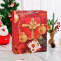 Large red Christmas gift bag with festive gold ornaments and white rope handles. - Christmas Red Gift Box / Medium 18x8.5x24cm