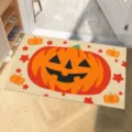 Halloween doormat featuring a large orange cartoon pumpkin on a beige background - Pumpkin Star Style (CHDT-2024-01335) / 40x60cm