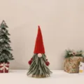 Detailed view of a Christmas tree gnome ornament with a red knitted hat and green felt. - Red Large (30cm)