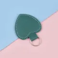 Dark green heart-shaped leather keychain with silver ring on pink and blue background - Dark Green