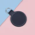 Porte-clés rond en cuir bleu marine avec surpiqûres blanches et anneau en métal - Noir