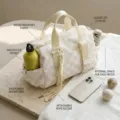 Detailed view of large checkered travel bag with secure zip and side bottle pocket - Beige