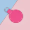 Porte-clés rond en similicuir rose avec coutures blanches et anneau en métal argenté - Rose rouge