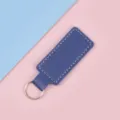 Moderner Schlüsselanhänger aus marineblauem PU-Leder mit weißen Nähten auf rosa-blauem Grund - Dunkelblau