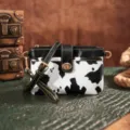 Detailed view of a western vintage cow print crossbody bag with golden buckle and yellow stitching - Cow Black (PG5051)