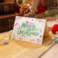 Hand-drawn 'Merry Christmas' cartoon greeting card with festive illustrations - Emerald Green Holiday Elements And Bunting Style (2025111702-3)