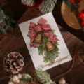 Tarjeta de felicitación navideña dorada con campanas y lazo sobre fondo de madera - Bells and Bow (4)
