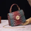 Detailed shot of the vintage red and blue gradient crocodile texture leather bag with gold lock - Jujube Red & Brown