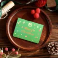 Festive green Christmas greeting card featuring gold foil Merry Christmas lettering - Wreath Style