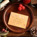 Christmas card with gold foil Merry Christmas text on wooden tray - Gingerbread Man Style