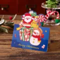 Vintage Christmas folding card with blue background, Santa and Snowman illustrations - Santa and Snowman