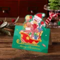 Vintage green Christmas folding gift card featuring snowman and sleigh illustration - Snowman