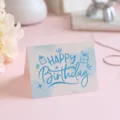 Artistic Happy Birthday greeting card featuring blue doodle text and cute gift icons. - Style 4