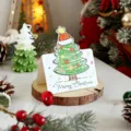 Small Christmas greeting card with a cute cartoon tree and Merry Christmas text on wood - Style 6