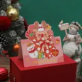 Festliche rosa Weihnachtsgrußkarte mit süßem Rentier-Cartoon und Merry Christmas Text - Weihnachtshirsch Stil