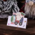 Carte de Noël avec un chien mignon conduisant un train festif sur une table en bois - Locomotive