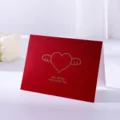 Minimalist red greeting card featuring a gold-stamped winged heart and best wishes text - Red