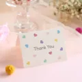 Elegant minimalist white 'Thank You' greeting card featuring colorful heart patterns - Thank You Style