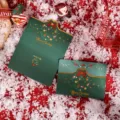 Dark green Christmas greeting card with gold foil wreath design on snow background - Christmas Wreath Style